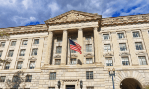 Historic building with American flag and blue sky.