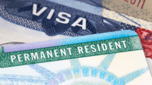 Close-up of a permanent resident card and a visa.