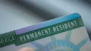 Close-up of a permanent resident card with the text visible.
