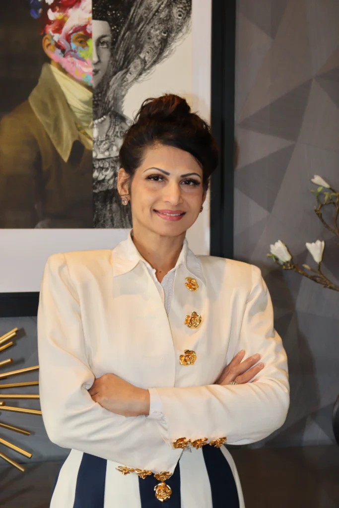 Professional woman standing with arms crossed, smiling.