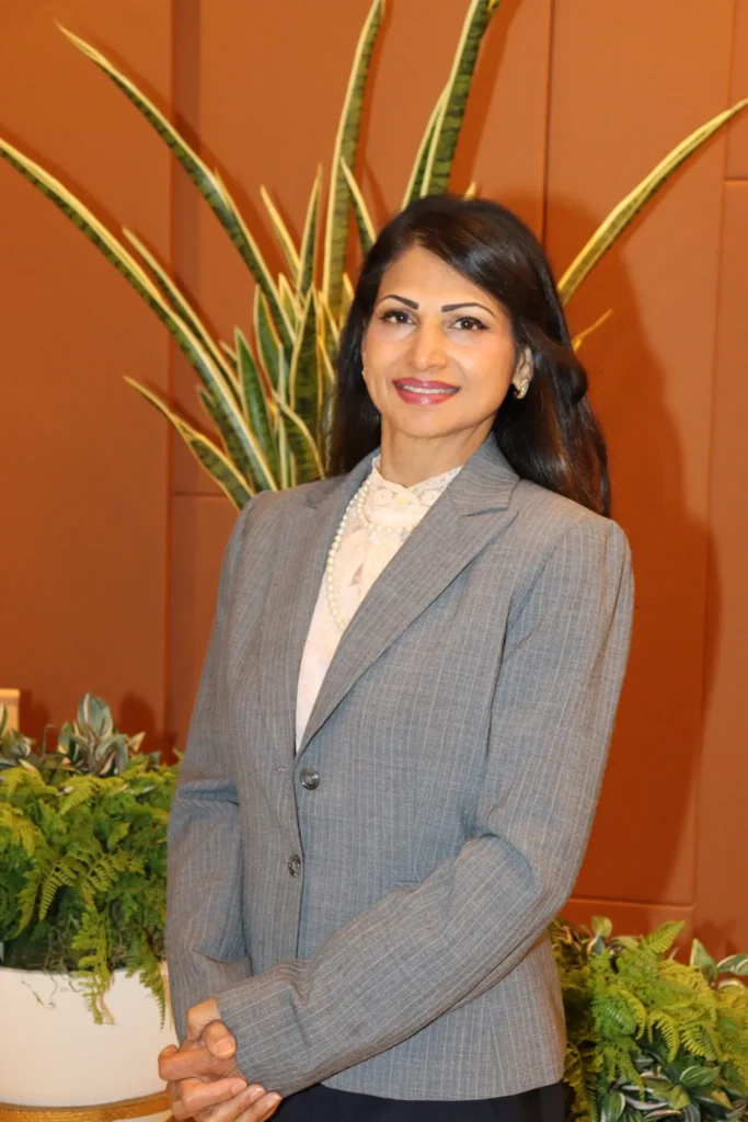 Smiling professional woman by indoor plants